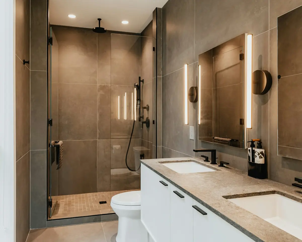 Modern bathroom with double vanity and a glass-walled shower