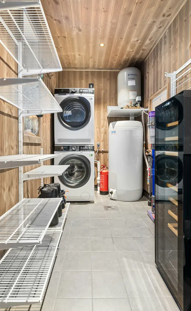 Tidy utility room with a new water heater and stacked laundry