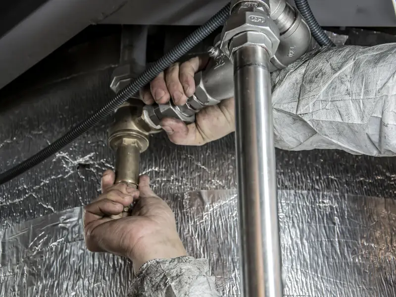 Technician installing steel pipe fittings