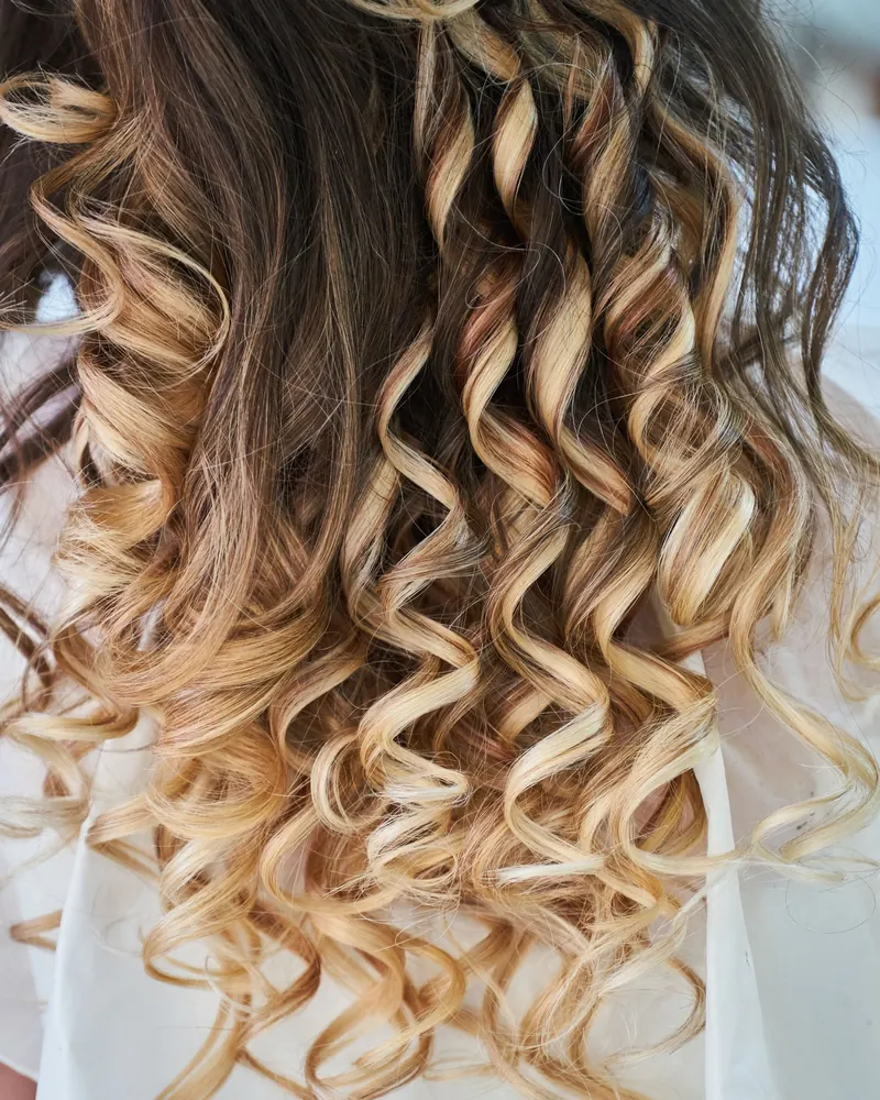 Close-up of defined curls with a brunette to blonde melt